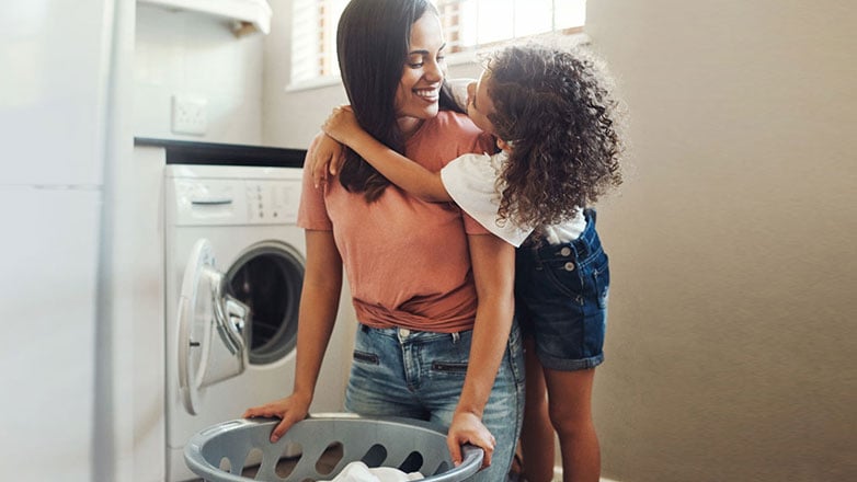 Mom and daughter playing in the laundry room.