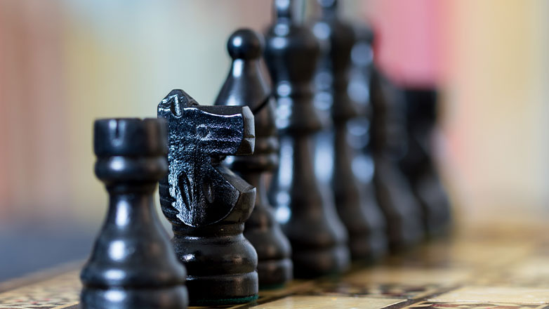 close up chess pieces with blurred background